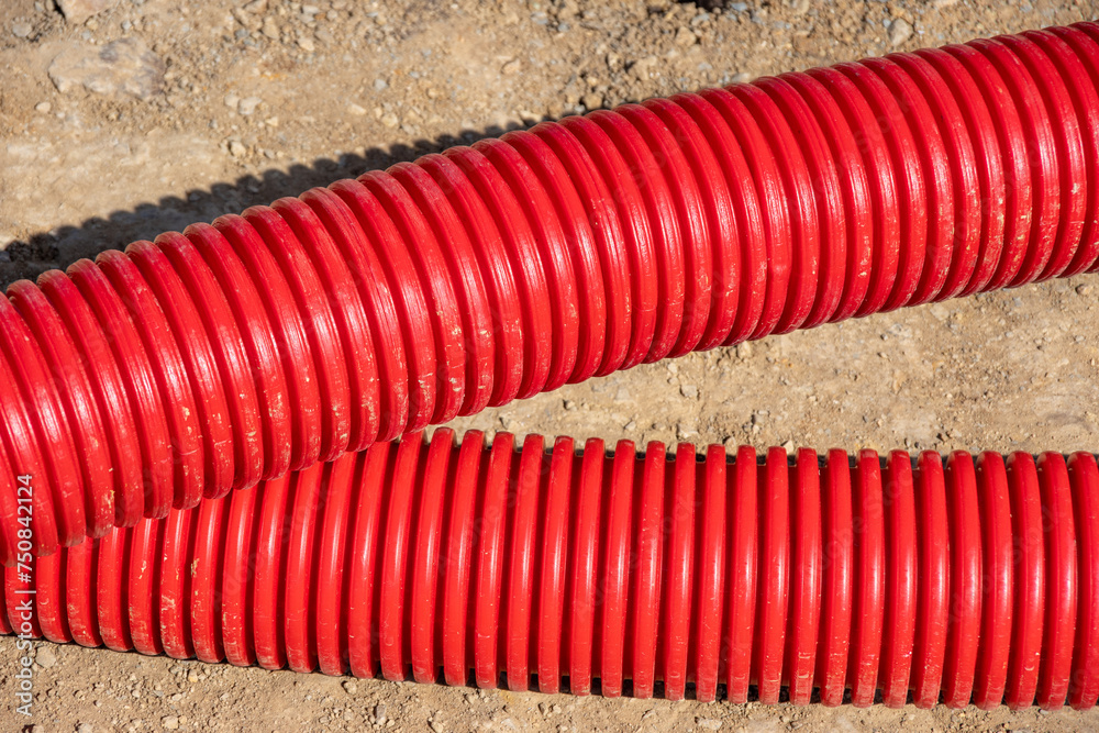 Red plumbing pipe close-up. Drainage, tubing, pipes. Red pipes of the water supply and heating system.