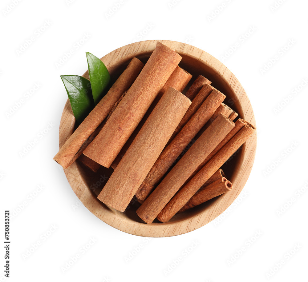 Cinnamon sticks and green leaves in bowl isolated on white, top view Cinnamon sticks and green leaves in bowl isolated on white, top view