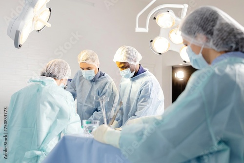 Group of doctors performing surgery in operating room