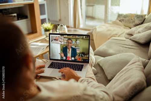 Man having video call with financial advisor from home