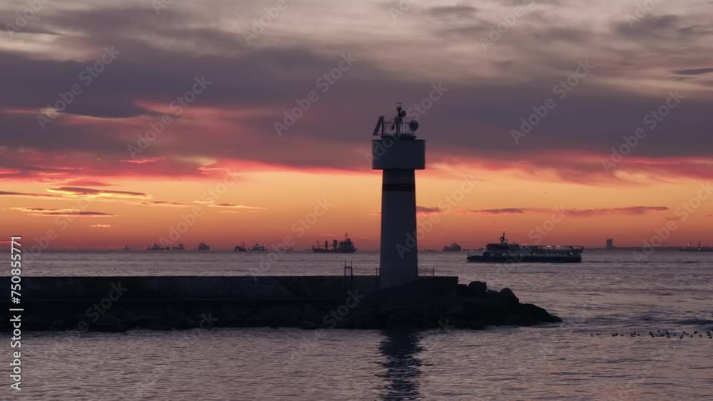 Stunning seascape view of lighthouse at sunset. A lot of ships on horizon Stunning seascape view of lighthouse at sunset. A lot of ships on horizon