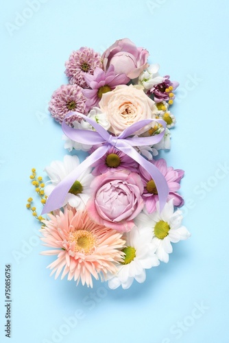 8 March greeting card design made with beautiful flowers on light blue background, top view