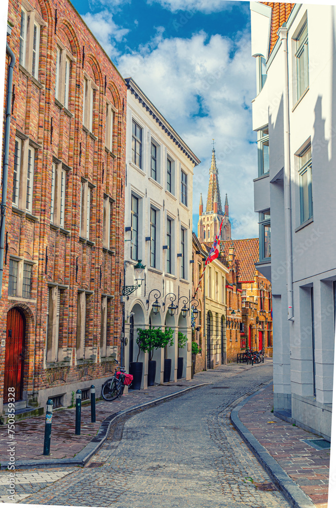 Bruges cityscape with empty narrow cobblestone street, buildings in Brugge city historical centre, Bruges old town Steenstraat quarter medieval district, vertical view, Flemish Region, Belgium