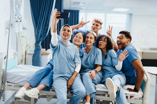 Group of nursing and medical students taking a celebratory selfie in a hospital photo
