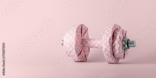 Fitness dumbbell wrapped in pink gift paper on pink pastel background with copy space. Creative fitness concept.