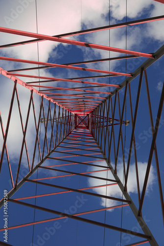 High Voltage Electricity Grid Pylon seen from below with blue sky photo