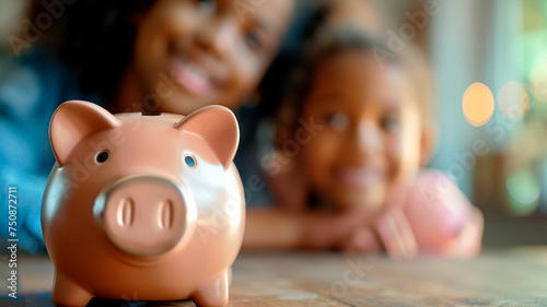 child holding coin in piggy bank with blurred home