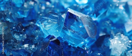 Detailed close-up of vibrant blue crystals in varying shapes and sizes, reflecting light and showcasing intricate natural formations.
