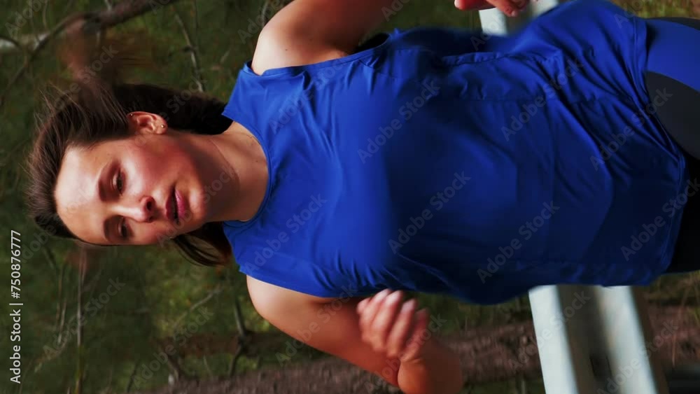 Portrait of woman running on empty road in forest in mountains. Vertical video Portrait of woman running on empty road in forest in mountains. Vertical video