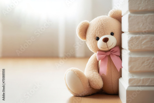 A teddy bear peek around the corner of the wall. Space for text.
