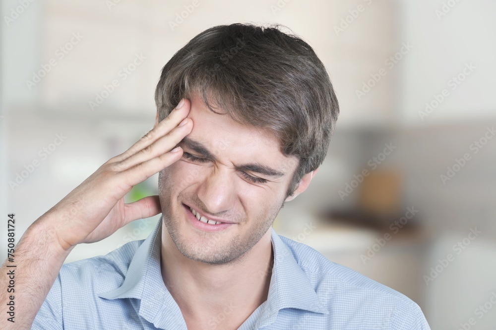Male sad suffering from awful headache Male sad suffering from awful headache
