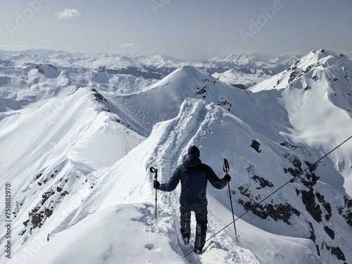 Ski tourer is out and about in a beautiful mountain landscape. Ski mountaineering in the beautiful Swiss mountains. Madrisa Rundtrip to Montafon Gargellen Luzein. Skimo skitour in the alps. photo