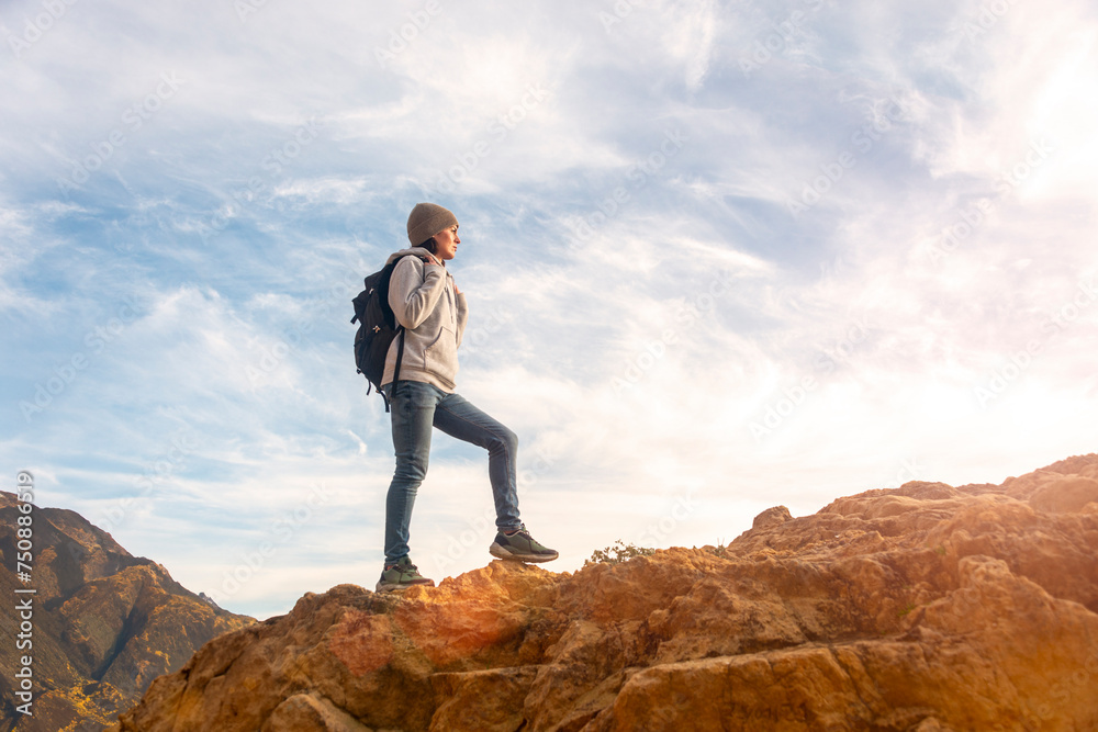 woman hiker with backpack walking up rocks, getting away from it all concept. woman hiker with backpack walking up rocks, getting away from it all concept.