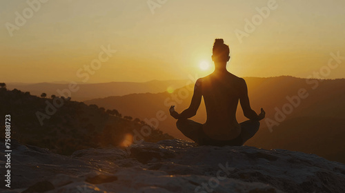 Man in yoga pose  zen meditation at sunset