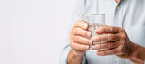 Hydration for health: Senior person holding a glass of water, staying healthy
