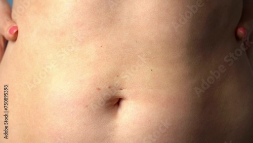 Wallpaper Mural Woman in close-up shows fat measurement. Fat belly. Medium size. Fat indicator on a blue background. High quality 4k footage. Torontodigital.ca