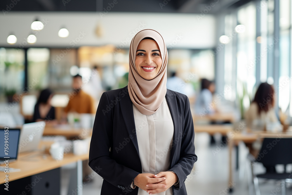Portrait of smiling beautiful modern Muslim businesswoman in casual business suit and traditional hijab standing in the modern office. Confident Arabian lady. Equal women rights in Eastern countries. - obrazy, fototapety, plakaty 