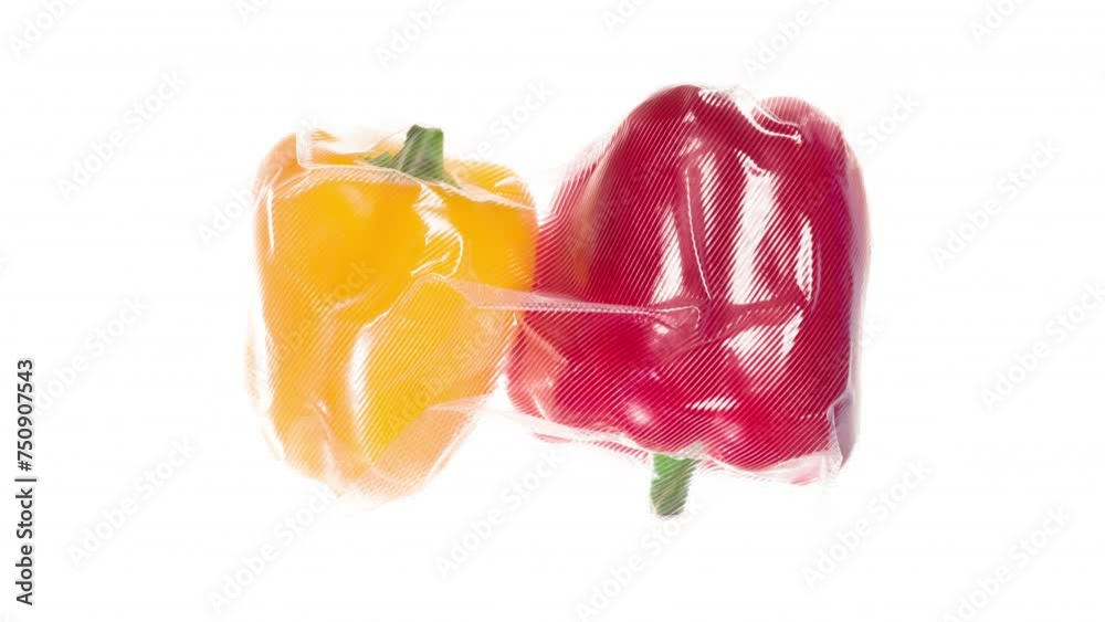 Packaging and Freezing Bell Peppers. Red and yellow bell peppers are vacuum packed and rapidly cooled with an ice jet, creating a white steam effect on a white background Packaging and Freezing Bell Peppers. Red and yellow bell peppers are vacuum packed and rapidly cooled with an ice jet, creating a white steam effect on a white background