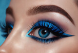 Close up of a woman's eye with blue and aquamarine eyeshadow. Eyeshadow. Makeup.