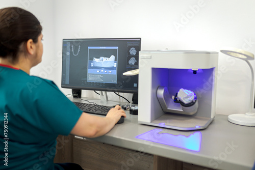 Dentist working on computer with a dental scan software for make dental prosthesis