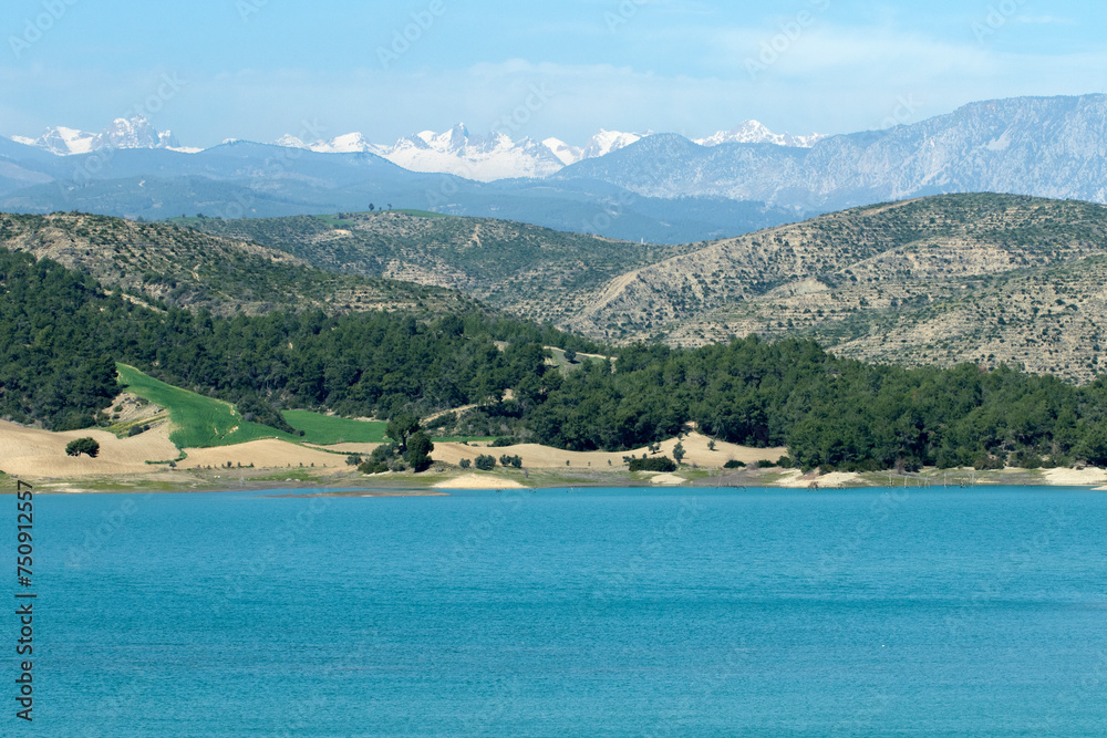 Catalan Dam Lake on Seyhan River and the Taurus Mountains behind in a spring day