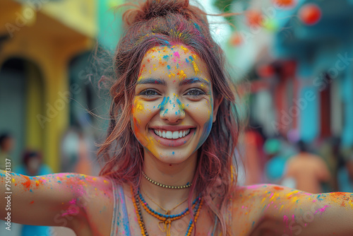 Happy young smiling girl with Holi powder on her body is celebrating Holi holiday. Selective focus. Copy space © Inga Bulgakova