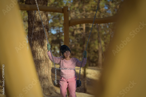 Little girl in an outdoor boat enjoying the hammocks