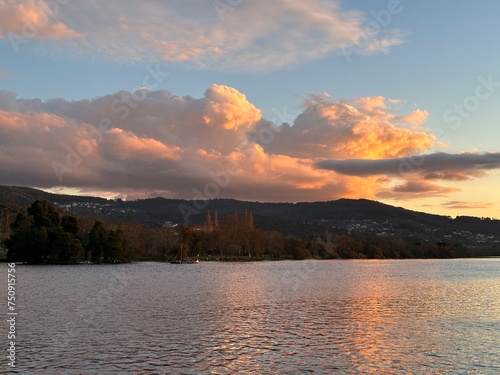 Colored sunset clouds over the river Minho, Vila Nova de Cerveira, Viana do Castelo, Portugal, December 2022 photo