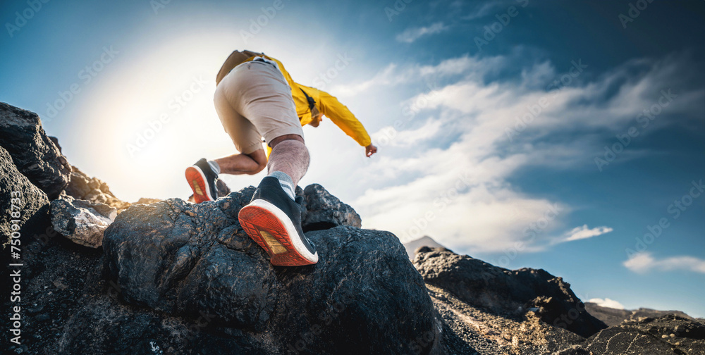 Male hiker climbing the mountain - Strong hiker standing on the top of the cliff enjoying sunset view - Extreme sport life style concept - obrazy, fototapety, plakaty 