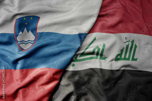 big waving national colorful flag of iraq and national flag of slovenia.