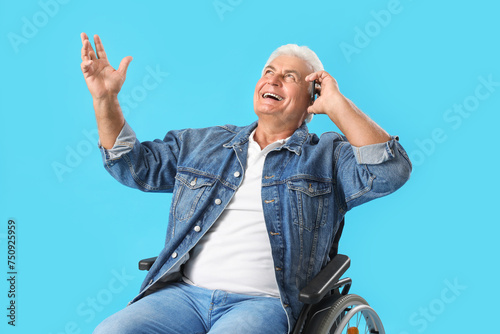 Mature man in wheelchair ta...