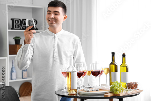 Young sommelier with glasse...