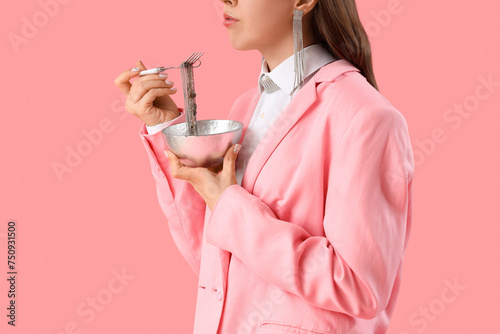 Woman with bowl eating silv...