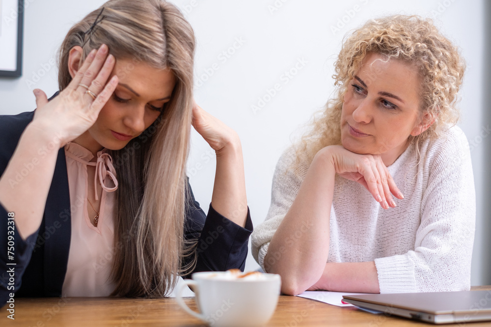 A distressed young woman in business attire is comforted by a concerned colleague, embodying the emotional toll of business failure and the need for support during tough times. A distressed young woman in business attire is comforted by a concerned colleague, embodying the emotional toll of business failure and the need for support during tough times.