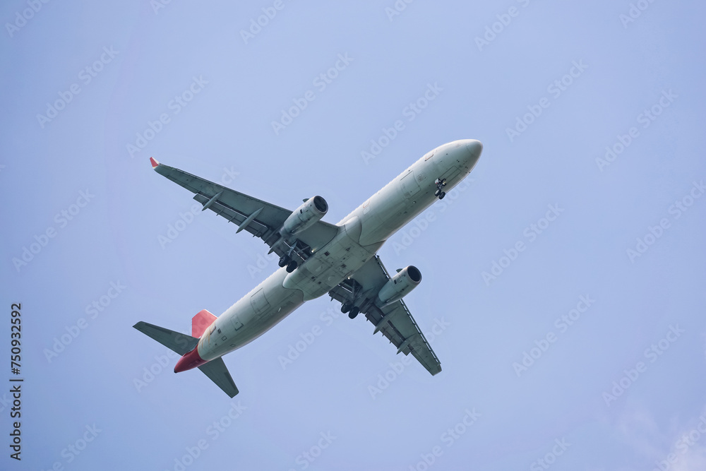 Airplane flying in sky with white clouds. Passenger plane at flight Airplane flying in sky with white clouds. Passenger plane at flight