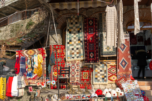Фотография Kruja old bazar with traditional carpet in  Albania in afternoon sky 3 march 202