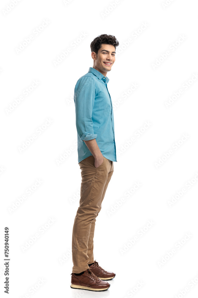 happy casual man waiting in line while holding pockets happy casual man waiting in line while holding pockets