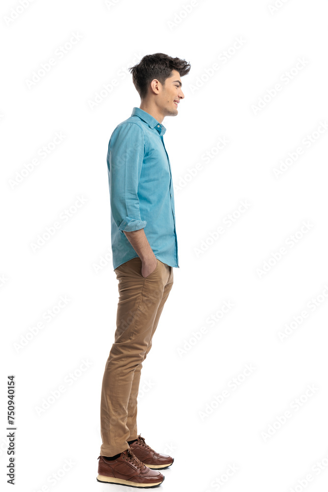 side view of relaxed casual man waiting in line side view of relaxed casual man waiting in line