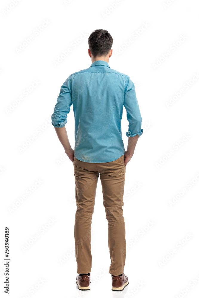 rear view of relaxed casual man holding pockets rear view of relaxed casual man holding pockets