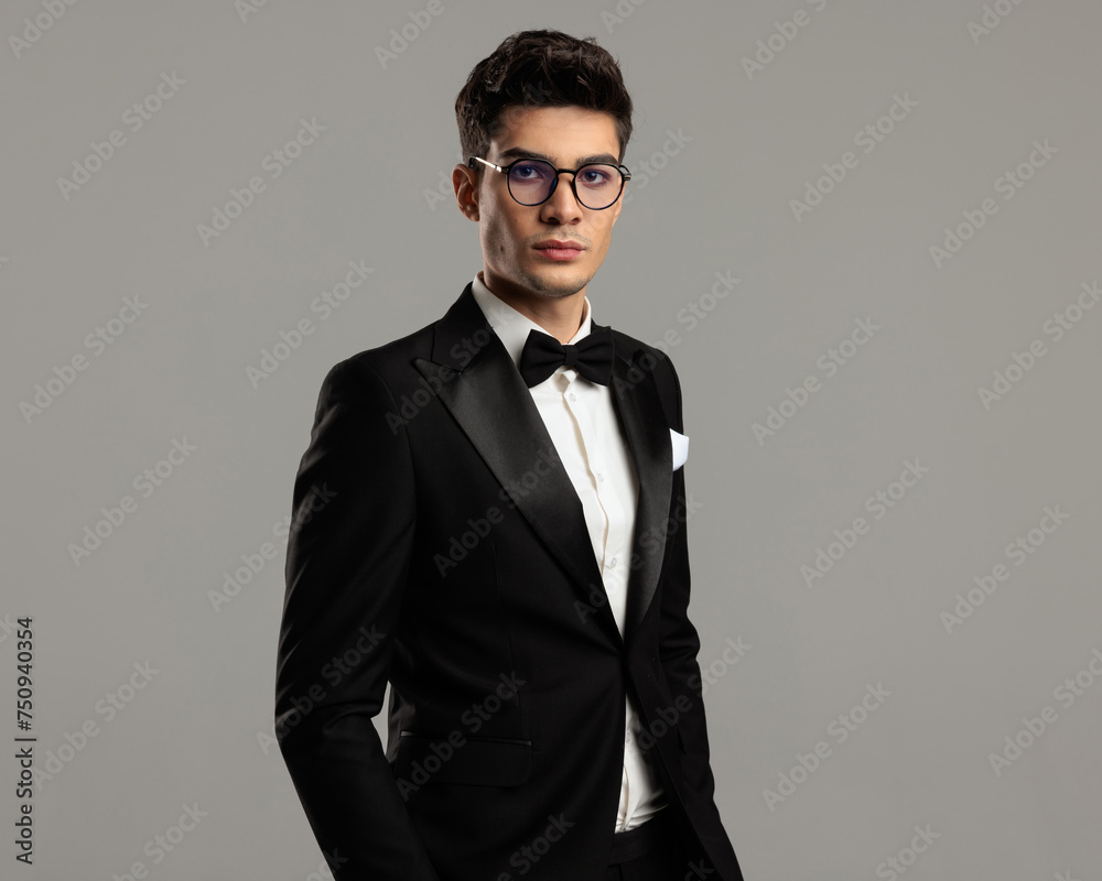 portrait of handsome groom wearing black tuxedo and glasses portrait of handsome groom wearing black tuxedo and glasses