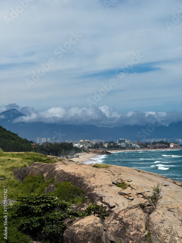 Macumba Beach and Recreio dos Bandeirantes in Rio de Janeiro  Brazil. Pedra do Pontal and Pedra da G  vea in the background. Beach on the west side of town. Sunny day and people on the beach