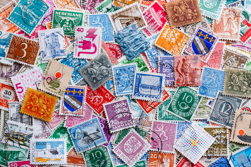 Postage stamps.A collection of world stamps in a pile.Postage stamps from different countries and times