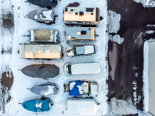 Drone view of camper, mobile home, and boat winter storage.