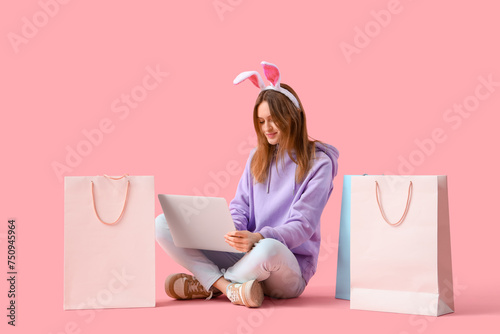 Young woman in bunny ears w...
