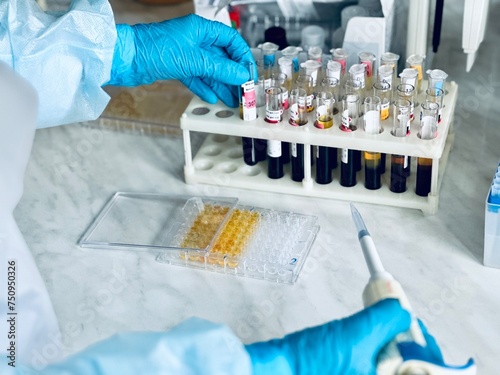 Canvas Print Scientist using multi-channel pipette to fill multiwell plate for analysis of an