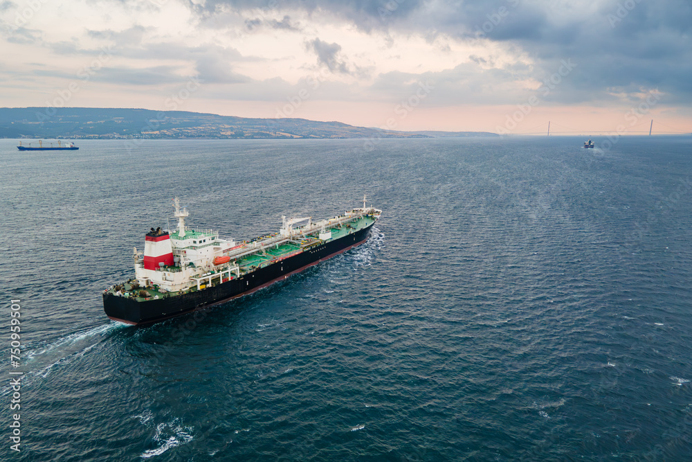 Crude Oil tanker carrier ship underway through Dardanelles Strait, aerial view, concept worldwide logistic and global trade