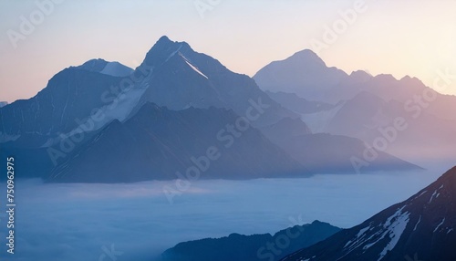 An image of epic mountains enveloped in morning fog, with sunlight casting a warm glow, creating a serene and majestic natural background. photo