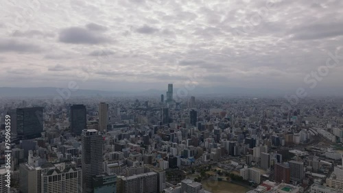 Wallpaper Mural Aerial ascending view of cityscape with modern high rise buildings. Cloudy sky above large city. Osaka, Japan Torontodigital.ca
