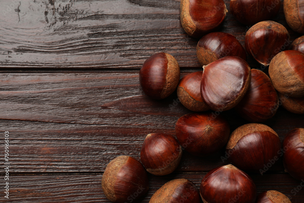 Sweet fresh edible chestnuts on wooden table, top view. Space for text Sweet fresh edible chestnuts on wooden table, top view. Space for text