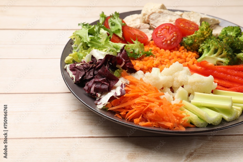 Balanced diet and healthy foods. Plate with different delicious products on light wooden table, closeup Balanced diet and healthy foods. Plate with different delicious products on light wooden table, closeup